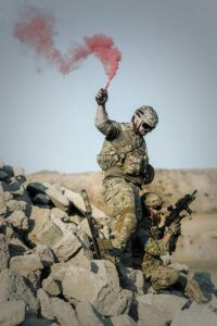 Photo by Pixabay: https://www.pexels.com/photo/2-soldier-with-guns-on-grey-pile-of-rocks-holding-smoke-stick-during-daytime-163489/