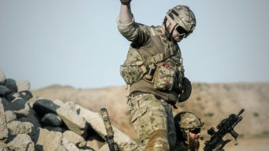 Photo by Pixabay: https://www.pexels.com/photo/2-soldier-with-guns-on-grey-pile-of-rocks-holding-smoke-stick-during-daytime-163489/
